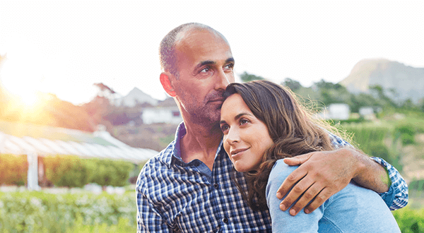 A man and woman embracing one another stock photo